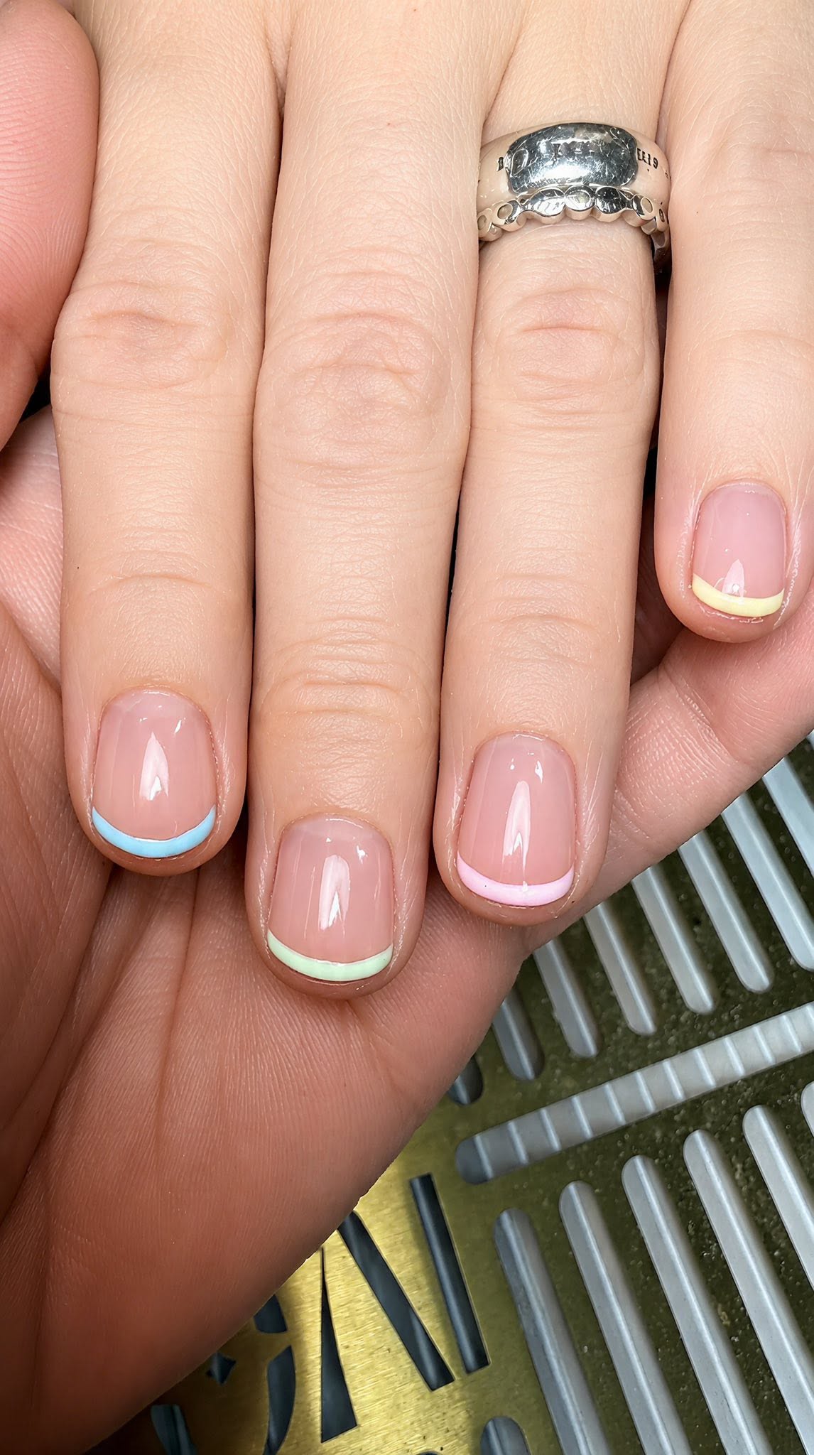 Manicured nails with a colourful French tip nail art design