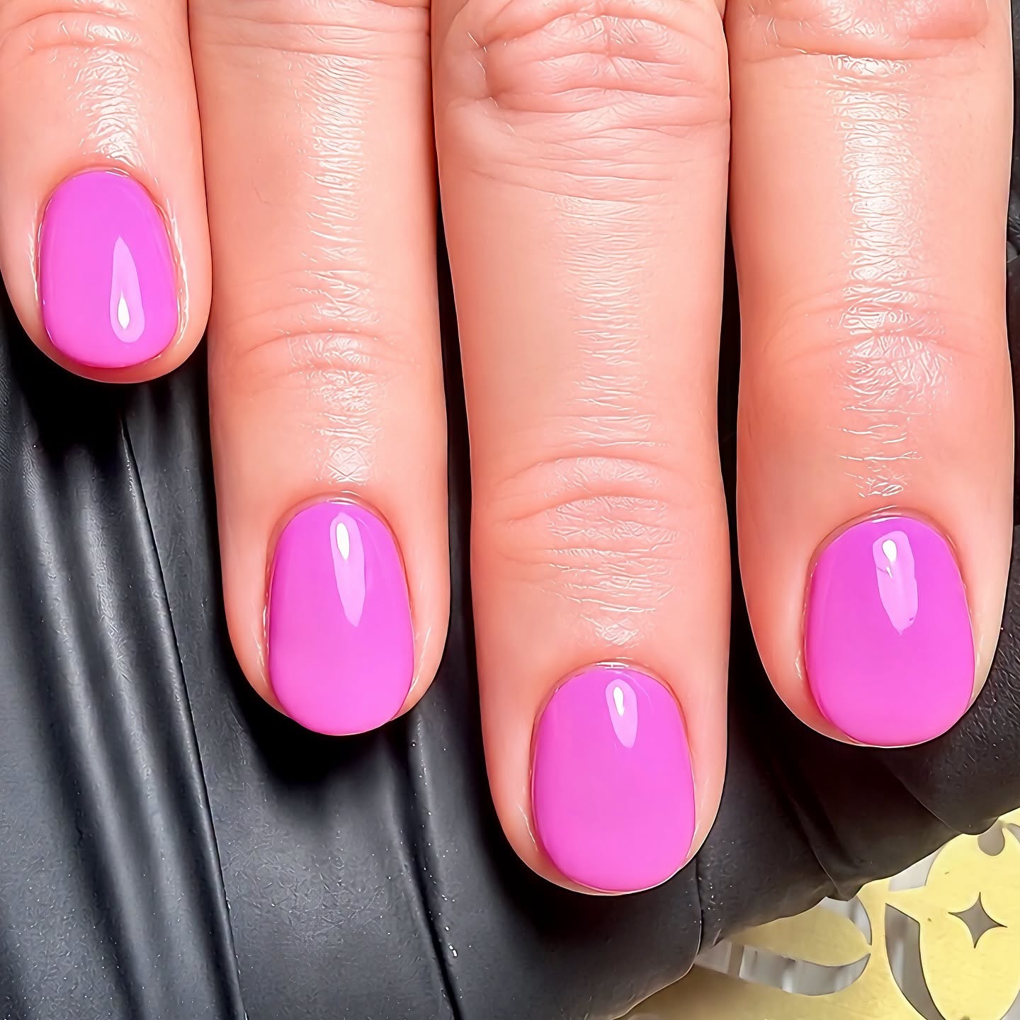 Bright magenta nail polish manicure with a glossy finish