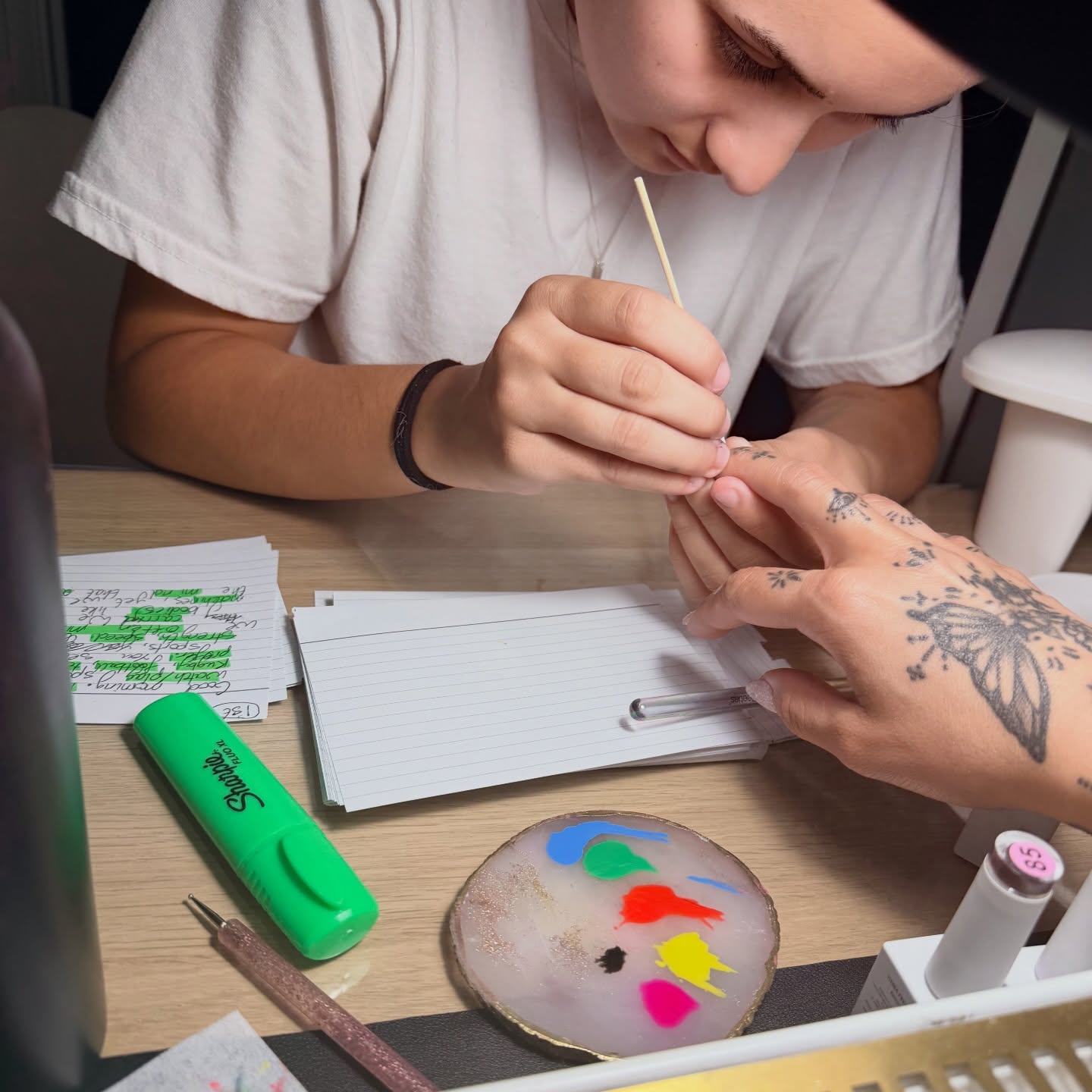 Creating nail art together at a table