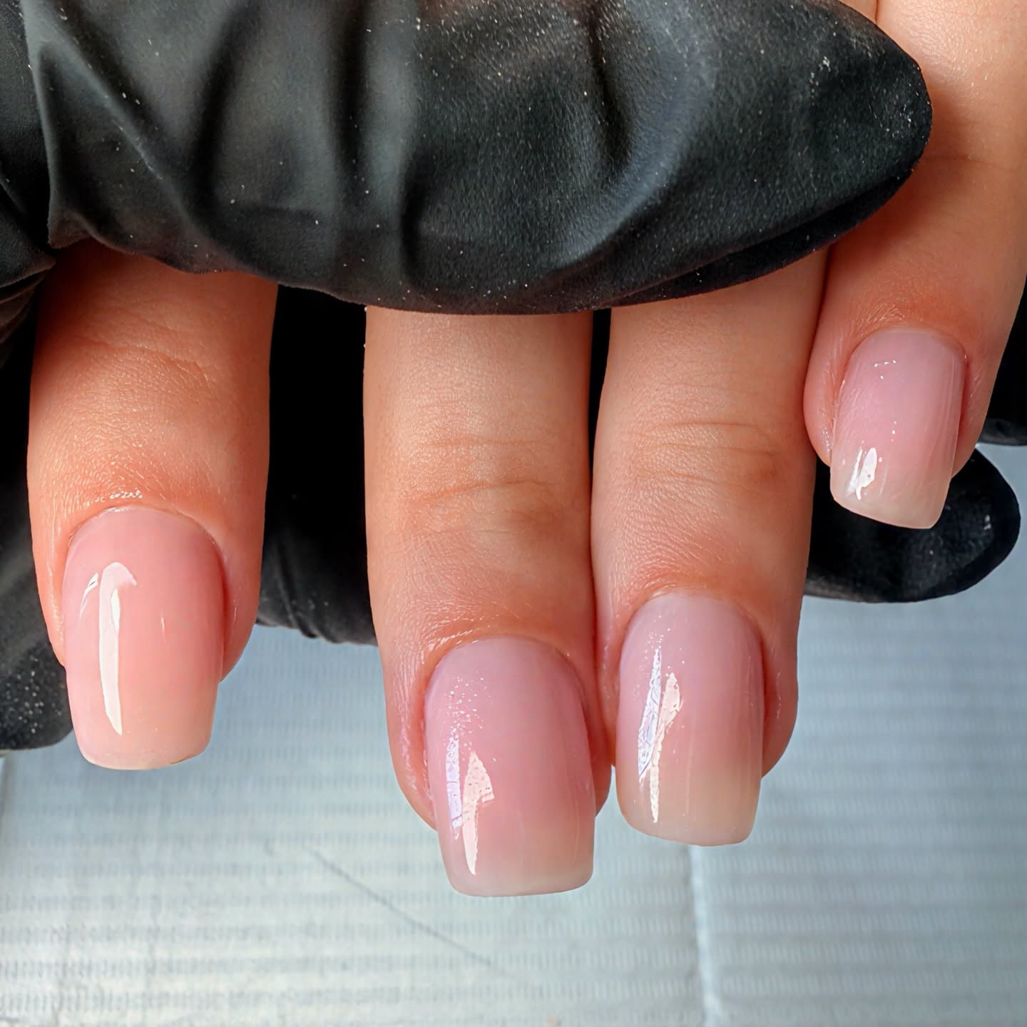 Close up of manicured nails with pink ombre gel polish