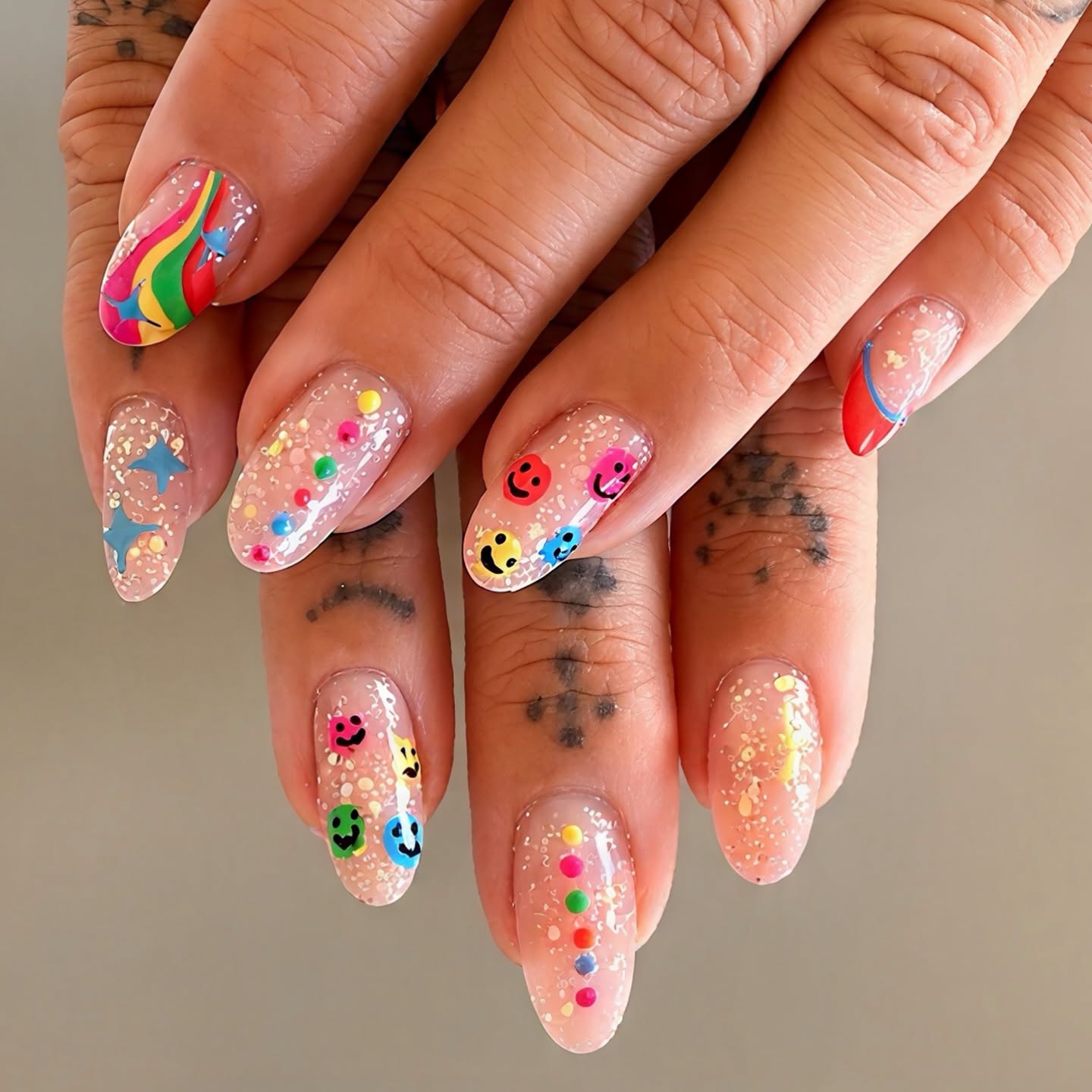 Colourful nail art designs with glitter and rainbow accents