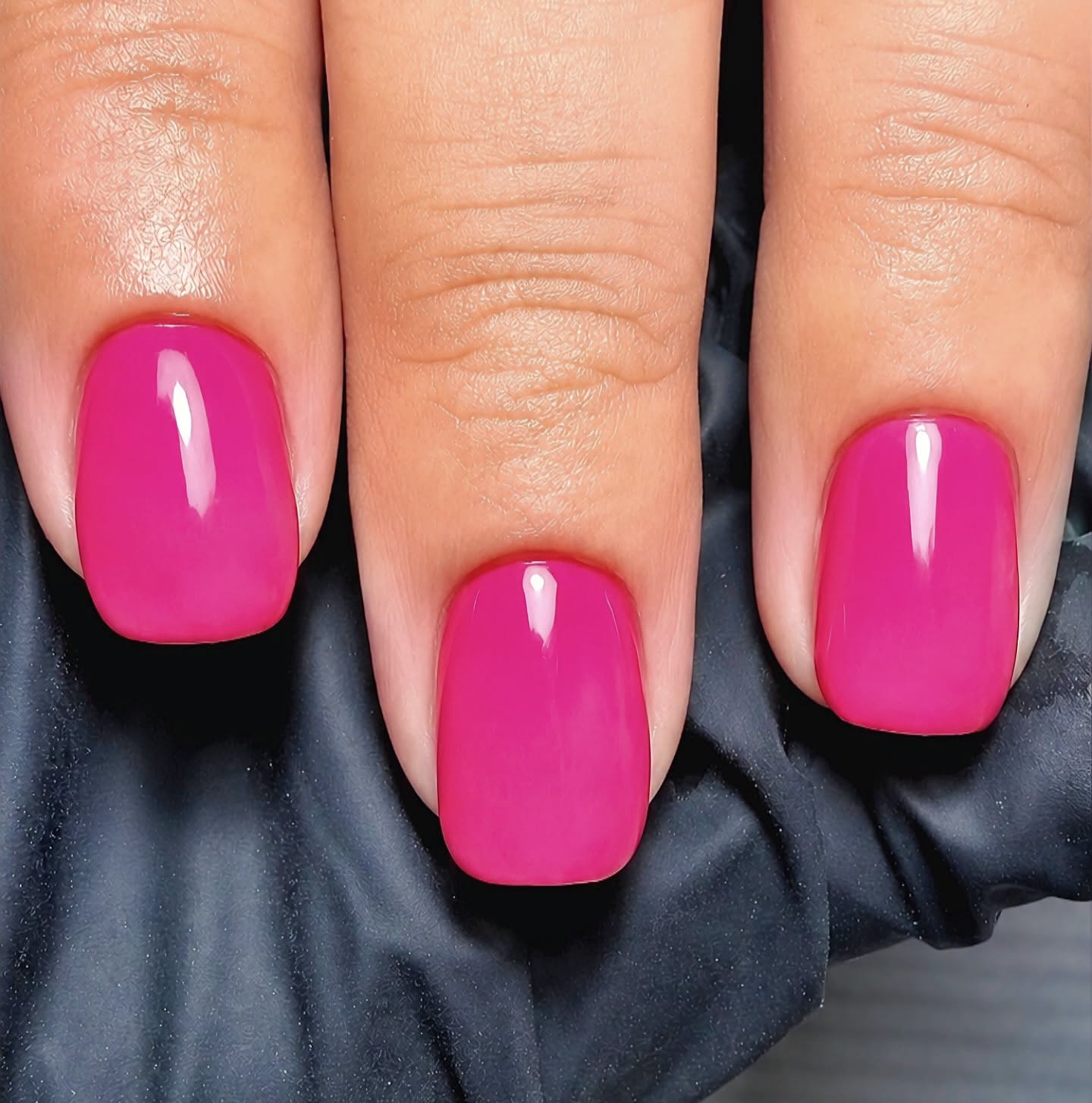 Bright pink gel manicure with a glossy finish